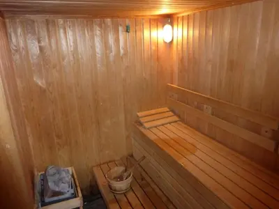 an empty wooden sauna with a bucket in it at Two-Bedroom Apartment in Fortuna in Bansko