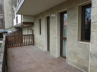 a front porch of a house with a balcony at Two-Bedroom Apartment in Fortuna in Bansko