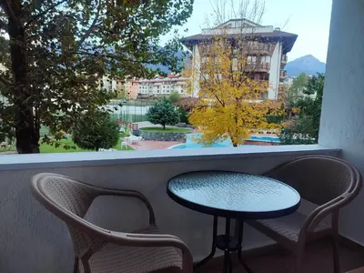 a table and two chairs in front of a window at Belvedere Holiday Club 2Bedroom Apartment F201 in Bansko
