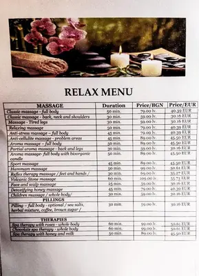 a menu for a restaurant with candles on it at Belvedere Holiday Club 2Bedroom Apartment F201 in Bansko