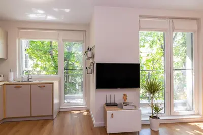 a living room with a flat screen tv on a wall at Center Apt - Free parking - Walk to Main Street in Plovdiv