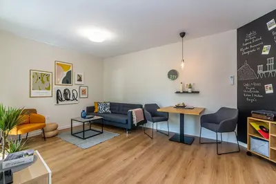 a waiting room with a couch and a table at Center Apt - Free parking - Walk to Main Street in Plovdiv