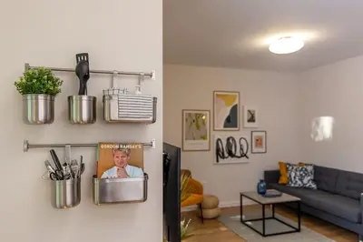 a living room with a blue couch and a living room with at Center Apt - Free parking - Walk to Main Street in Plovdiv