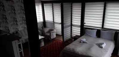 a bedroom with a bed with white sheets and pillows at Kapana Plovdiv in Plovdiv
