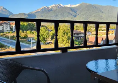 a balcony with a table and a view of mountains at 