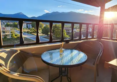 a table and chairs on a balcony with a view at 