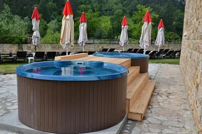 a patio with two tables and some umbrellas at Apartment in Hotel Sveti Spas 5 Velingrad in Velingrad