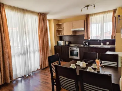 a kitchen with a table and chairs and a dining room at Dream 1BRoom Private Apartment in Bansko