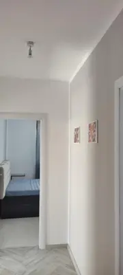 a bedroom with a bed in a white wall at O pulse Sofia apartment in Sofia