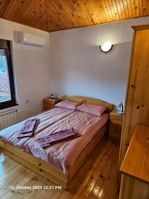 a bedroom with a bed with two towels on it at Villa Dilyanka Stokite in Stoykite