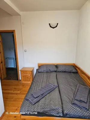 a bed in a bedroom with two towels on it at Villa Dilyanka Stokite in Stoykite