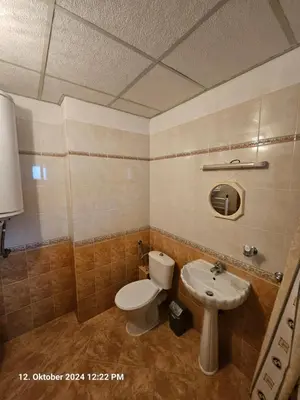 a bathroom with a toilet and a sink at Villa Dilyanka Stokite in Stoykite
