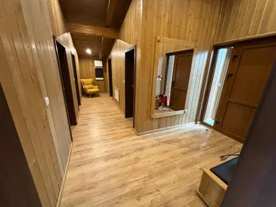 a hallway of a house with wooden floors and doors at Villa Pirin Golf in Bansko