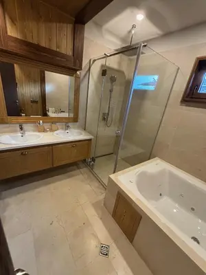 a bathroom with two sinks and a shower and a tub at Villa Pirin Golf in Bansko