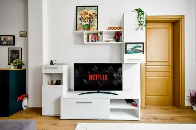 a living room with a white entertainment center at Large 2-BR Retreat, Walk to Sofias Top Spots in Sofia