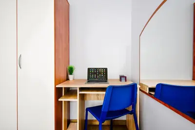 a desk with a laptop and two blue chairs at Large 2-BR Retreat, Walk to Sofias Top Spots in Sofia
