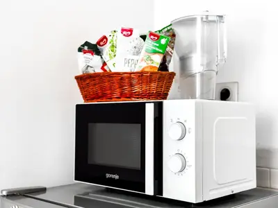 a microwave with a basket on top of it at Prime Spot - 2BR -15BTH - Next to Nevsky Church in Sofia