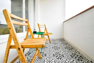 two chairs sitting on a balcony with a tile floor at Work Friendly 2BR AC Terrace Str Parking in Sofia