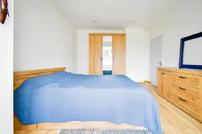 a bedroom with a blue bed and a flat screen tv at Work Friendly 2BR AC Terrace Str Parking in Sofia