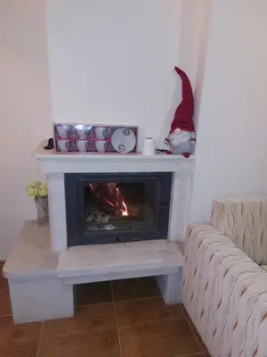 a fireplace with a santa hat on top of it at Апартамент в Лъки Пампорово комплекс in Pamporovo
