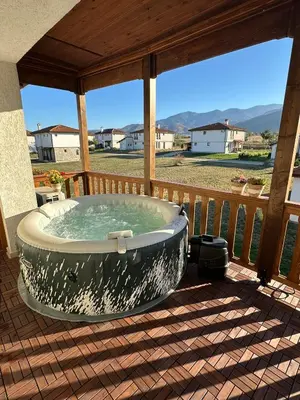 a hot tub on the deck of a house at Villa Vista in Dolna Banya