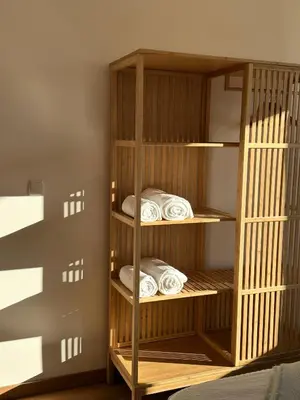 a book shelf with folded towels in a room at Villa Vista in Dolna Banya