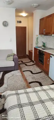 a living room with a couch and a kitchen at Gondola area, Cedar Lodge 4, apart D30, Bansko in Bansko