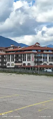 an empty parking lot in front of a large building at Gondola area, Cedar Lodge 4, apart D30, Bansko in Bansko