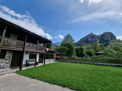a house with a yard with mountains in the background at Къща за гости Имало едно време in Smolyan