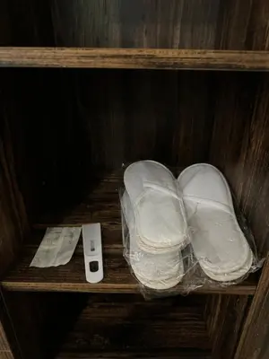 a wooden shelf with two plastic wraps and a remote control at Borovets Gardens Chill Hill Studio by Joro in Borovets