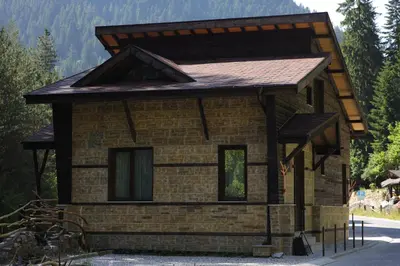 a small brick house with a brown roof at Horlog Castle in Trigrad
