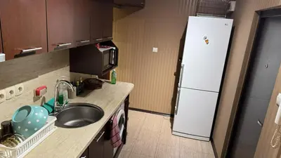 a small kitchen with a sink and a refrigerator at Astoriq in Sofia