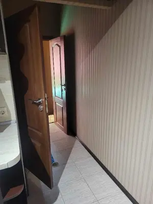 a room with a door and a person standing in a hallway at Astoriq in Sofia