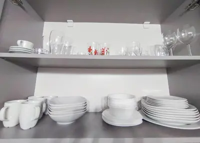 a shelf with plates and bowls and wine glasses at Deluxe Apartment In Belvedere With Terrace in Bansko