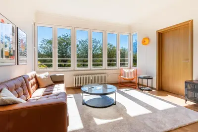 a living room with a couch and a table at The Architect Home - City Center, Free Parking! in Sofia