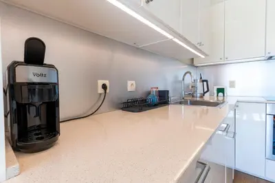 a kitchen with a coffee maker on a counter at The Architect Home - City Center, Free Parking! in Sofia