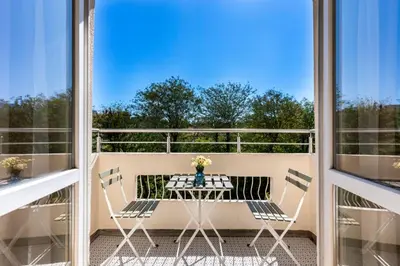 a patio with a table and chairs on a balcony at The Architect Home - City Center, Free Parking! in Sofia