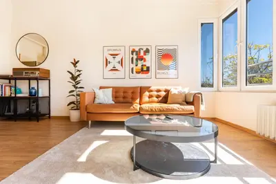 a living room with a couch and a glass table at The Architect Home - City Center, Free Parking! in Sofia