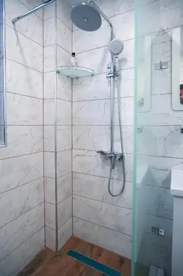 a shower with a glass door in a bathroom at Sun City Apartment in Sandanski