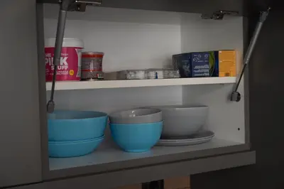 a shelf with three blue bowls on it at Sun City Apartment in Sandanski