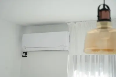 a light hanging from a ceiling next to a window at Sun City Apartment in Sandanski