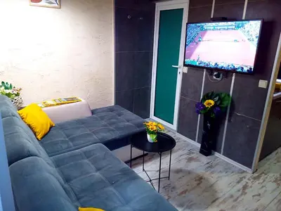 a living room with a couch and a flat screen tv at Apartment Lion's bridge 2 - Top Center in Sofia