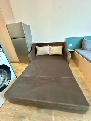 a large bed in a room with a couch at Noble House Comfort Place in Sofia
