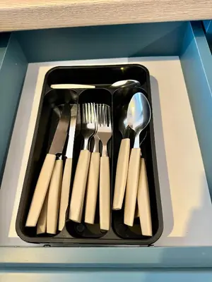 a black tray with utensils in a drawer at Noble House Comfort Place in Sofia