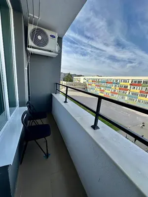 a room with a balcony with a chair and a building at Noble House Comfort Place in Sofia