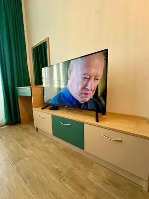 a flat screen tv sitting on top of a dresser at Noble House Comfort Place in Sofia