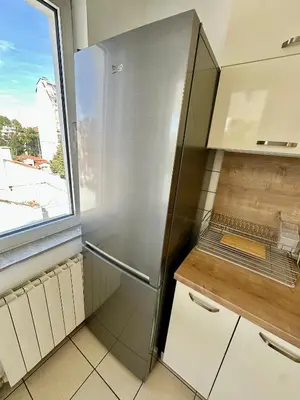 a kitchen with a refrigerator and a window at Central District 3 Bedroom Place in Plovdiv
