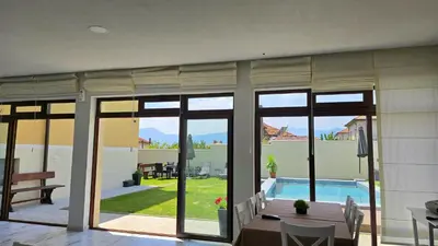 a living room with a view of a swimming pool at Самуил къща за гости in Ognyanovo