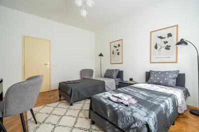 a bedroom with a bed and a desk and a chair at Modern and Calm 2BDRM Apt in City Centre in Sofia