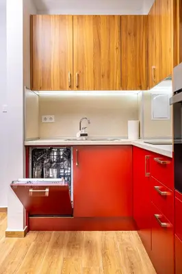 a kitchen with red cabinets and a sink at Bright and Cozy Apartment Next to a City Park by Flat Mаnager in Plovdiv